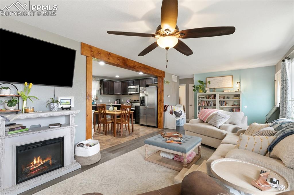 89 Security Boulevard Colorado Springs, CO 80911 - Photo 7 of 29 a living room with furniture a fireplace and a flat screen tv
