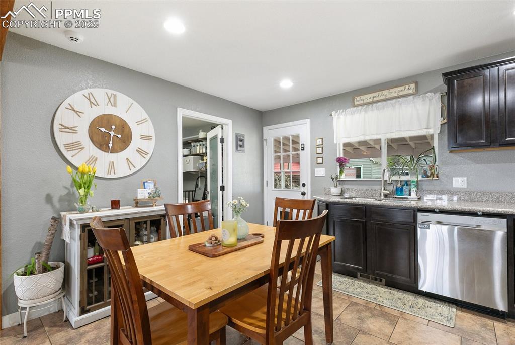 89 Security Boulevard Colorado Springs, CO 80911 - Photo 9 of 29 a kitchen with a table and chairs in it