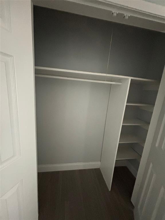 301 Rolston Road, Unit 315101 Irving, TX 75060 - Photo 7 of 12 Built-in closet system with hanging rod, multiple shelving units, and wood-finish flooring