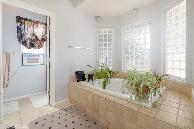 a bathroom with a tub sink and mirror