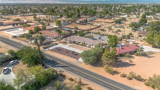an aerial view of residential houses with outdoor space and river