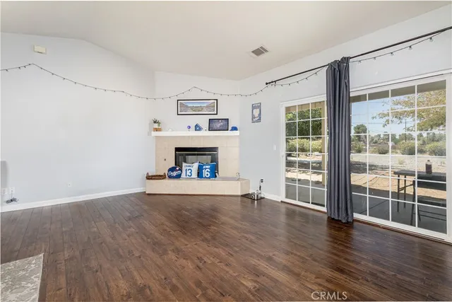 wooden floor fireplace and natural light in room