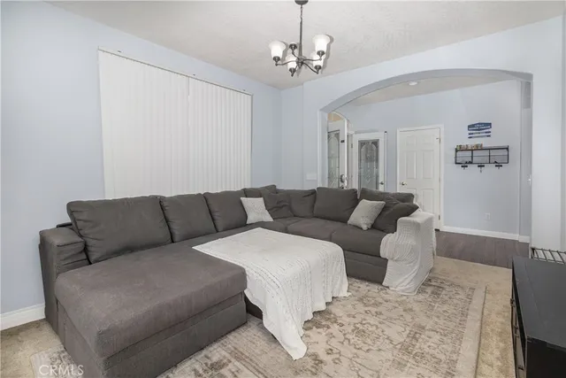 a living room with furniture and a chandelier