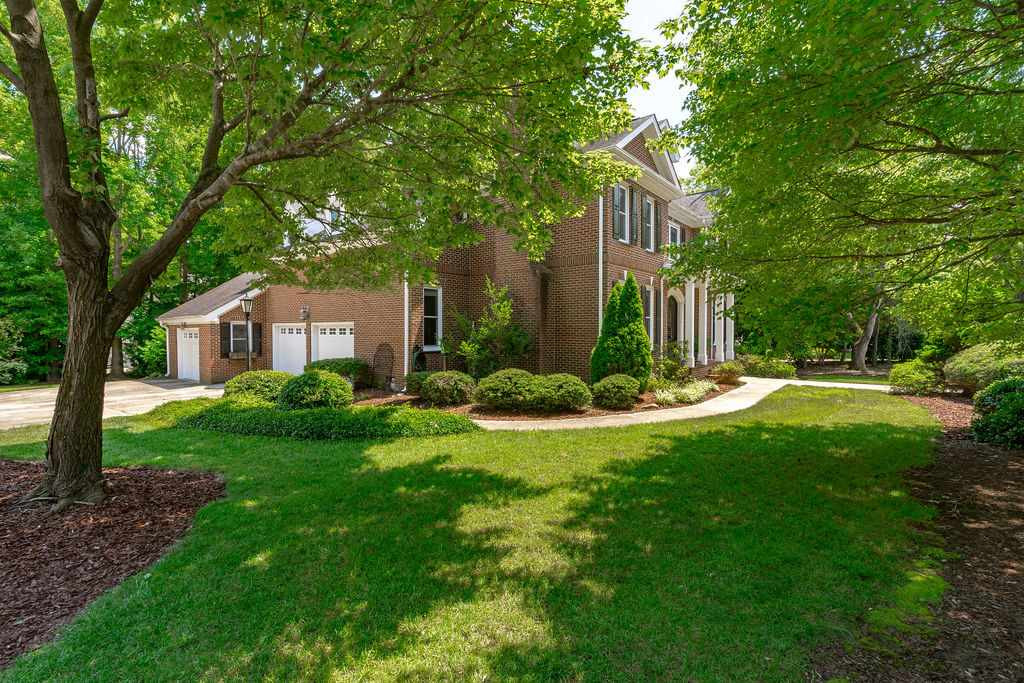 4901 Salem Ridge Road Holly Springs, NC 27540 - Photo 4 of 30 3-car garage on a separate driveway entrance than the circular drive. Pristine Landscape with Mature Cherry Tree Providing an Abundance of Shade