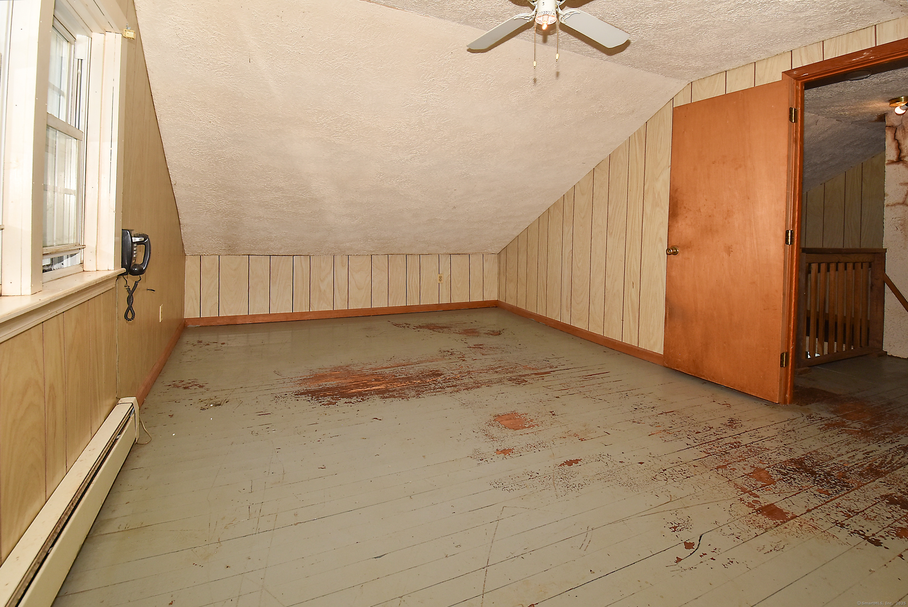 Undisclosed Address Vernon, CT 06066 - Photo 15 of 34 a view of a livingroom with wooden floor and a ceiling fan