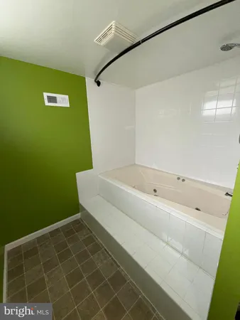 a bathroom with a bathtub and a toilet