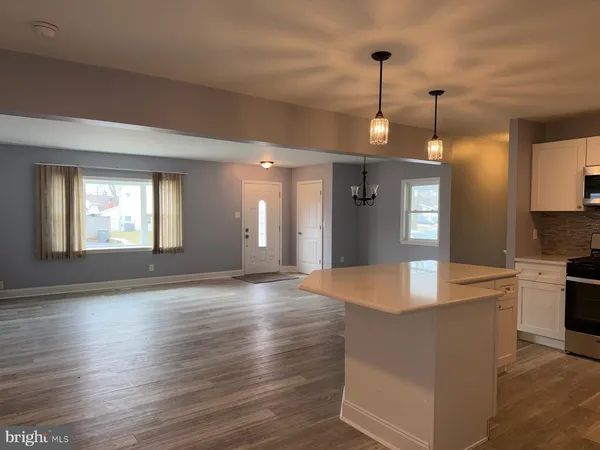 a view of kitchen with cabinets and wooden floor