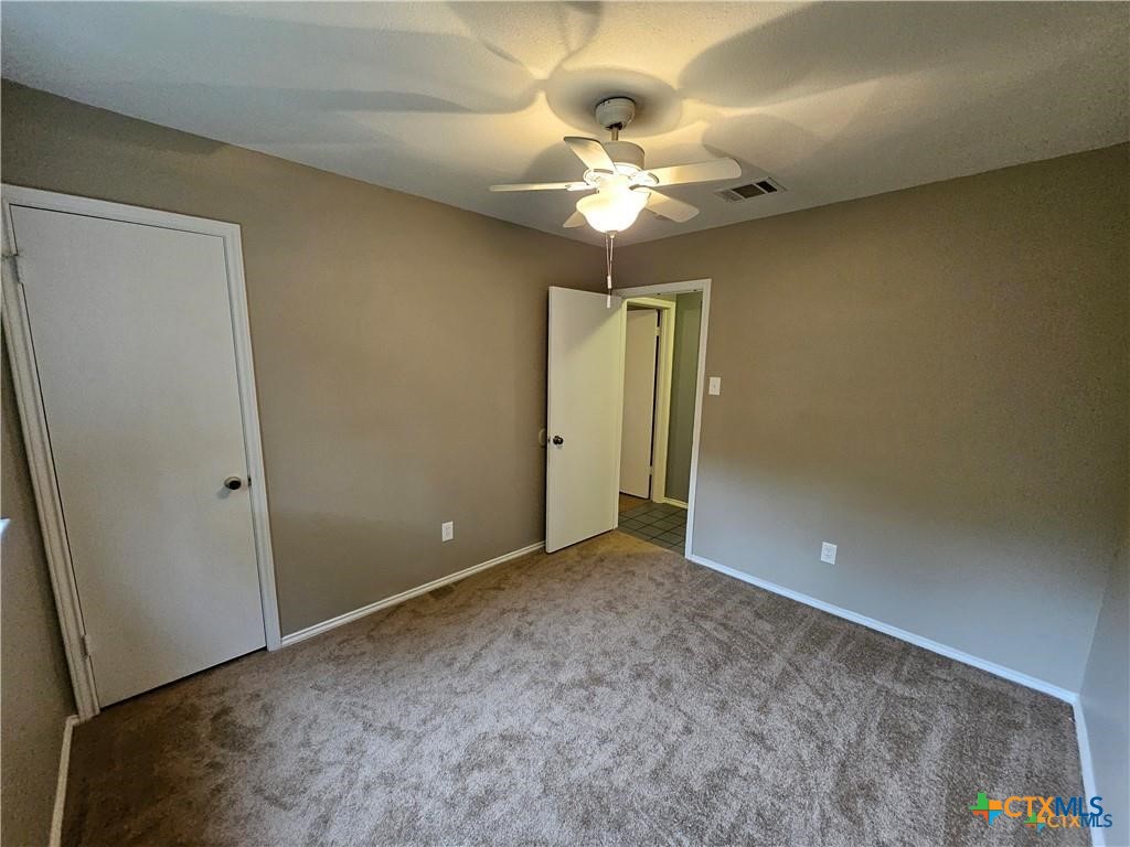 4402 Keota Drive Austin, TX 78749 - Photo 19 of 37 an empty room with a chandelier fan and a large window
