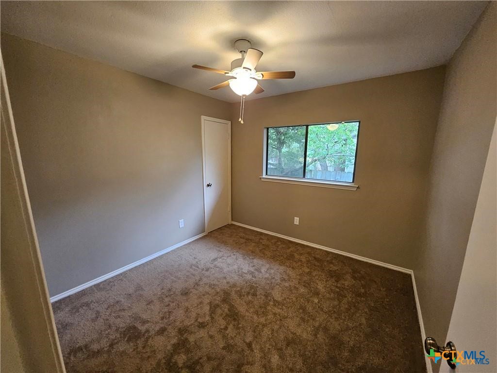 4402 Keota Drive Austin, TX 78749 - Photo 32 of 37 an empty room with windows and ceiling fan