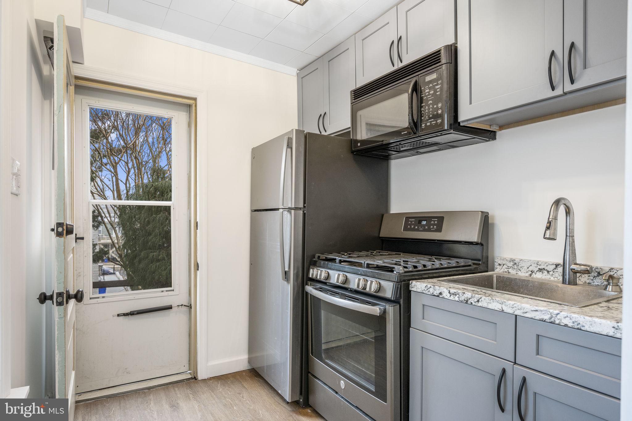 207 Kline Street Reading, PA 19611 - Photo 4 of 24 a kitchen with stainless steel appliances granite countertop a refrigerator stove and sink