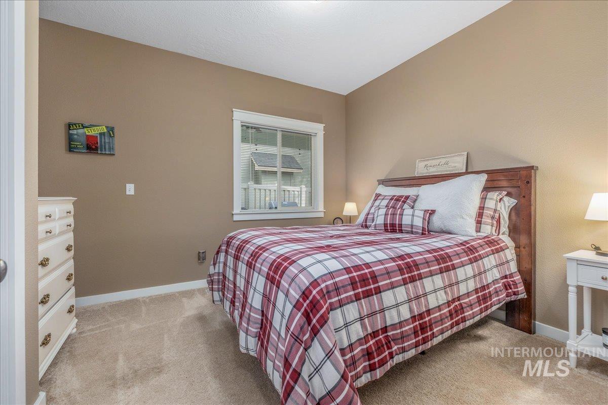3038 North Christian Way Meridian, ID 83646 - Photo 22 of 48 Bedroom with light carpet and baseboards