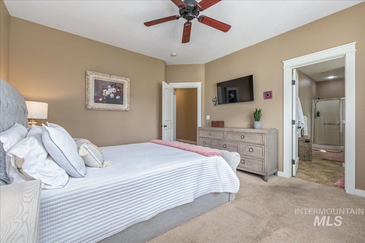3038 North Christian Way Meridian, ID 83646 - Photo 25 of 48 Bedroom with ceiling fan, carpet floors, and connected bathroom