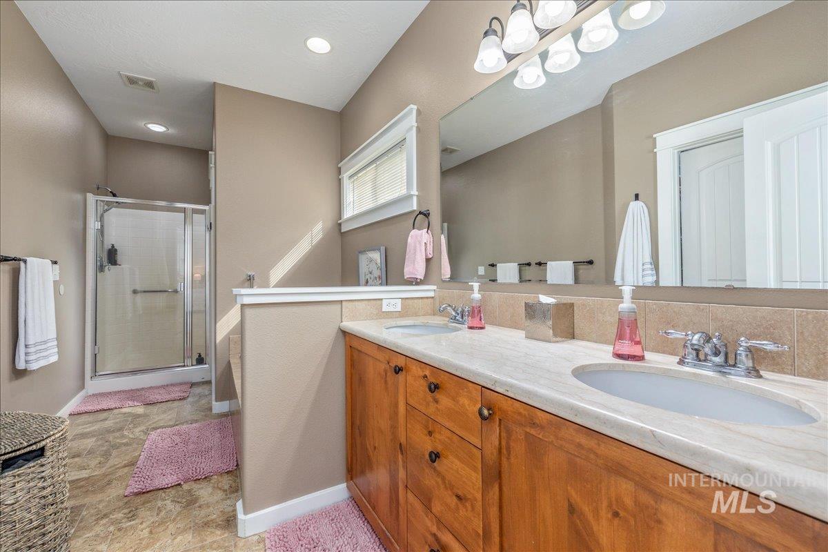 3038 North Christian Way Meridian, ID 83646 - Photo 26 of 48 Full bath featuring double vanity and a stall shower