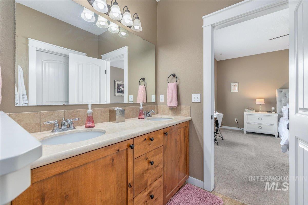 3038 North Christian Way Meridian, ID 83646 - Photo 27 of 48 Ensuite bathroom with double vanity and light colored carpet