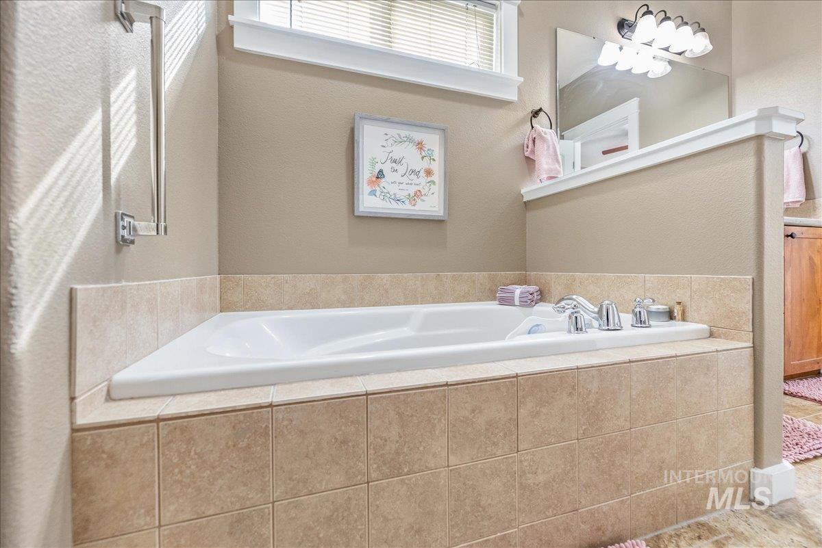 3038 North Christian Way Meridian, ID 83646 - Photo 28 of 48 Full bathroom with a bath, vanity, and a textured wall