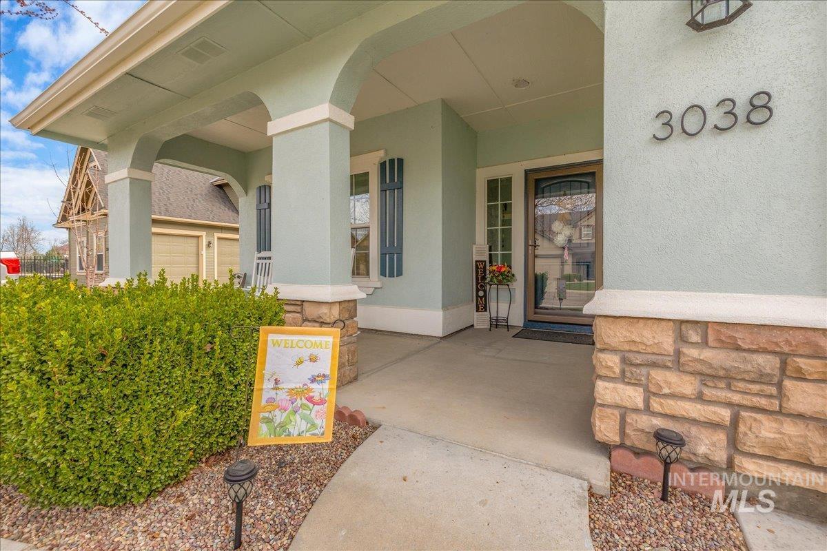3038 North Christian Way Meridian, ID 83646 - Photo 3 of 48 View of exterior entry with a porch, stucco siding, and stone siding