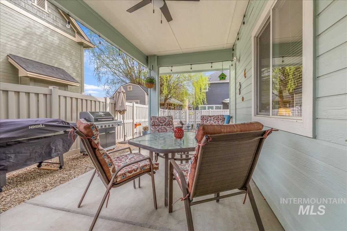 3038 North Christian Way Meridian, ID 83646 - Photo 39 of 48 Fenced backyard featuring a patio, a grill, outdoor dining area, and a ceiling fan