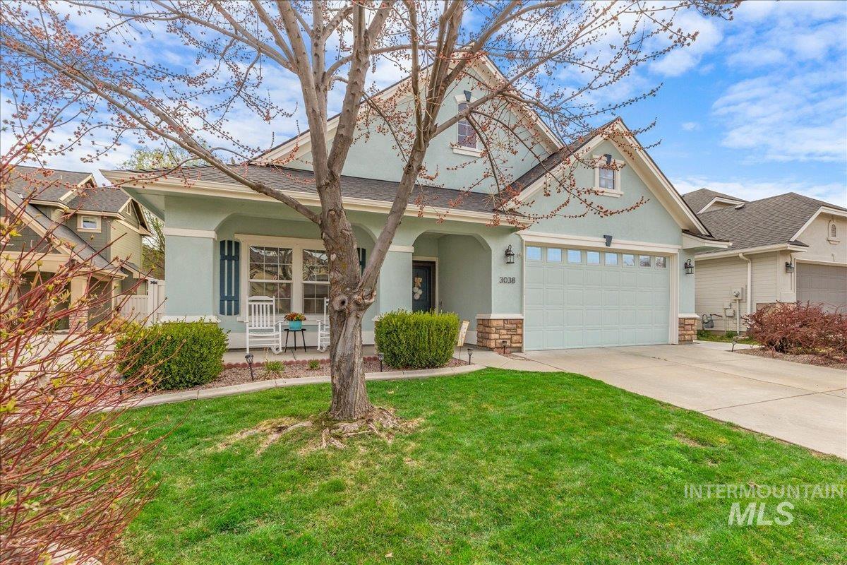 3038 North Christian Way Meridian, ID 83646 - Photo 43 of 48 View of front of house featuring stucco siding, a porch, a front lawn, driveway, and stone siding