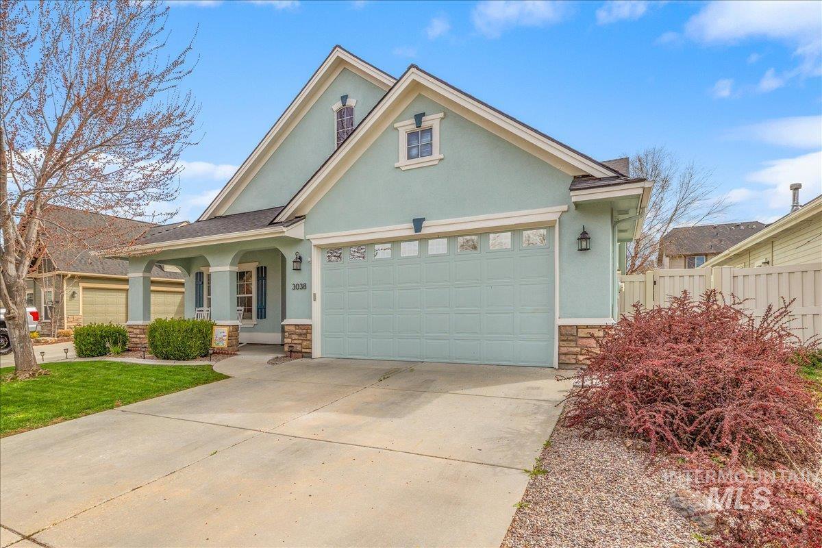 3038 North Christian Way Meridian, ID 83646 - Photo 46 of 48 View of front of home with stone siding, stucco siding, driveway, covered porch, and a garage