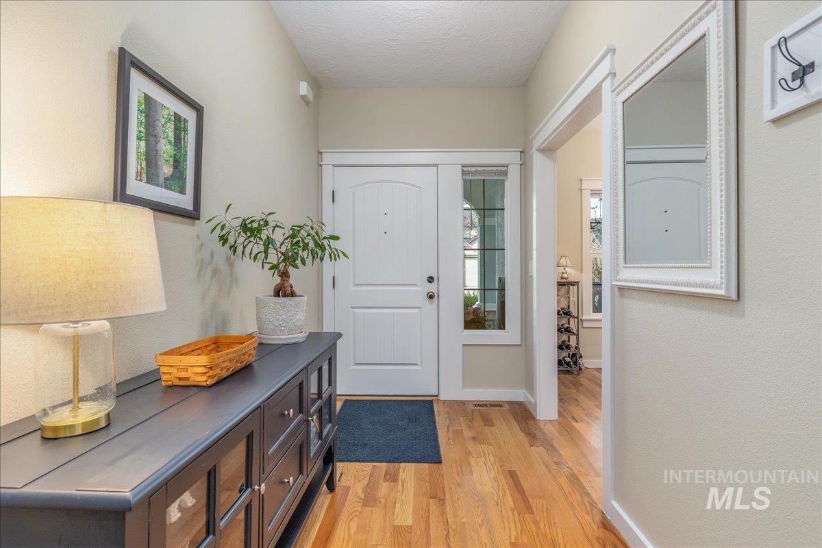 3038 North Christian Way Meridian, ID 83646 - Photo 5 of 48 Entryway with light wood-style floors, a textured wall, and a textured ceiling