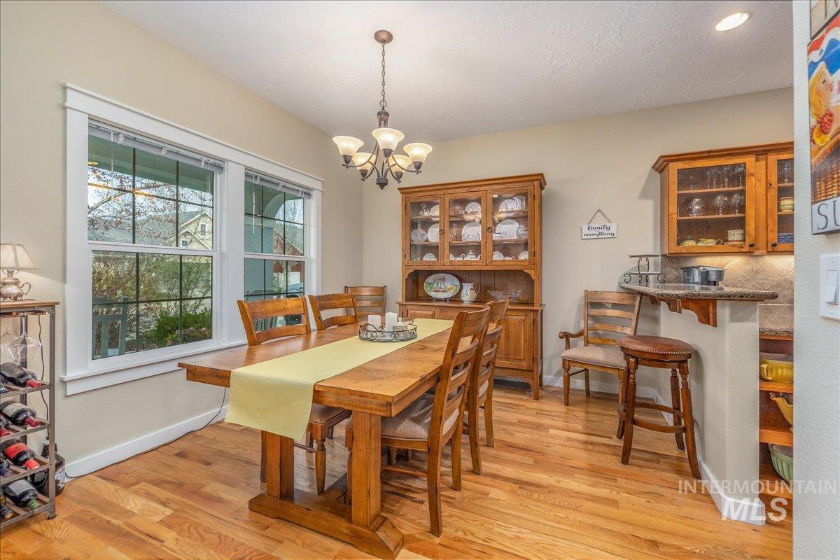 3038 North Christian Way Meridian, ID 83646 - Photo 7 of 48 Dining area with light wood finished floors and suspended lighting