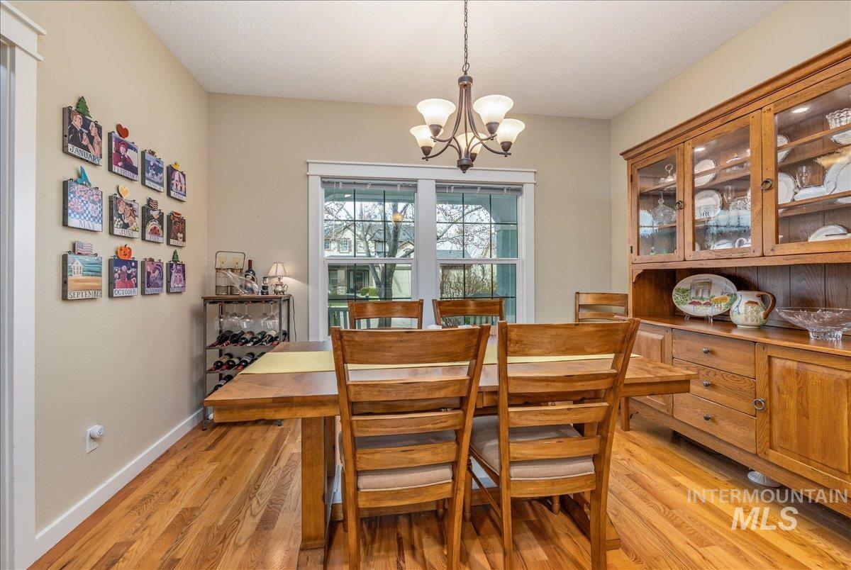 3038 North Christian Way Meridian, ID 83646 - Photo 8 of 48 Dining space with light wood-style floors and hanging lights