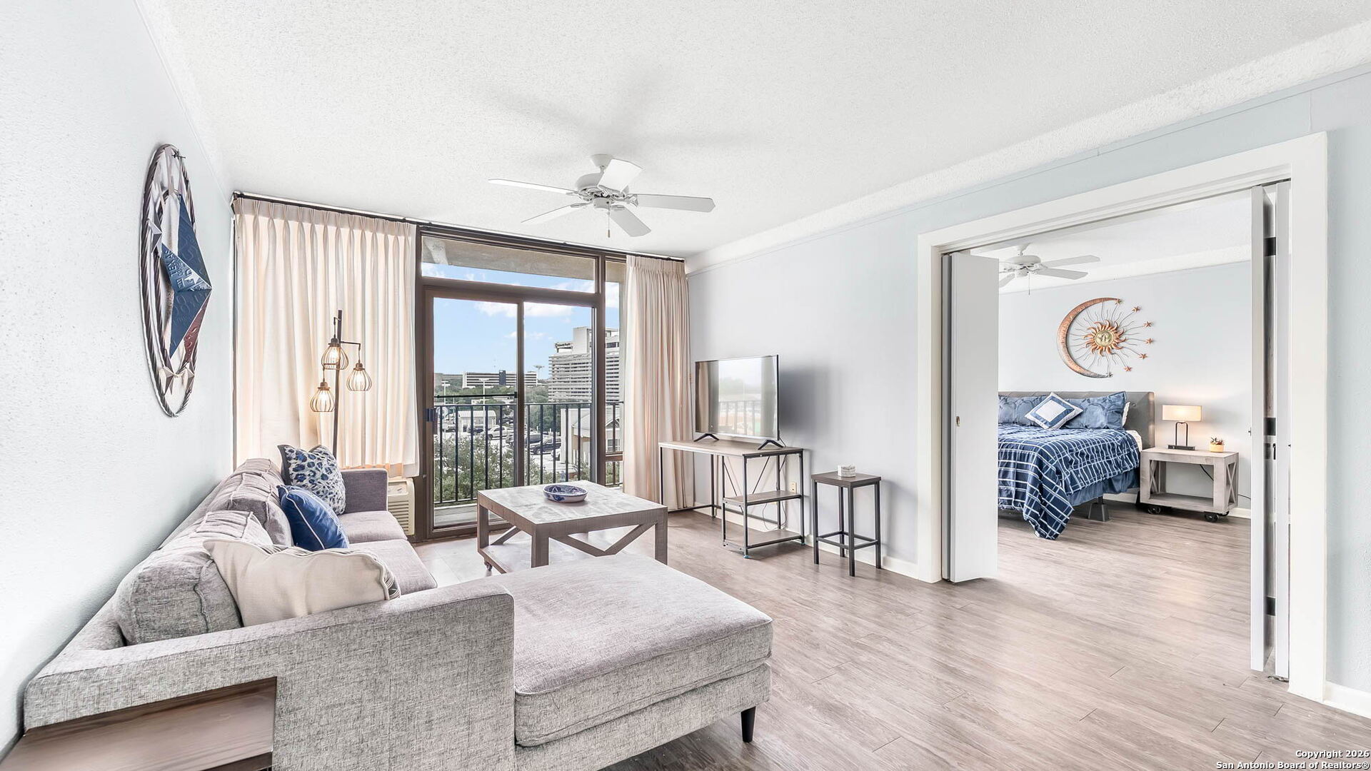 7701 Wurzbach Road, Unit 606 San Antonio, TX 78229 - Photo 1 of 10 a living room with furniture and a large window