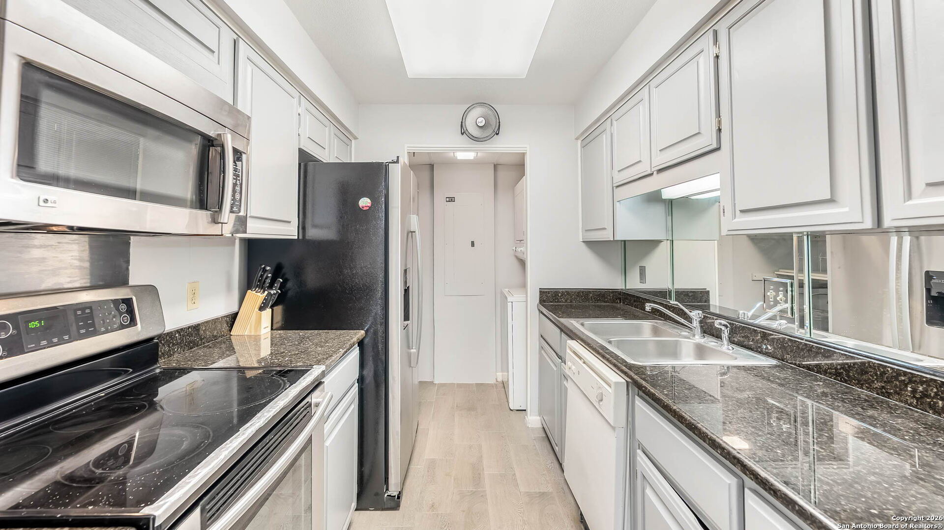 7701 Wurzbach Road, Unit 606 San Antonio, TX 78229 - Photo 2 of 10 a kitchen with stainless steel appliances granite countertop a sink and a stove