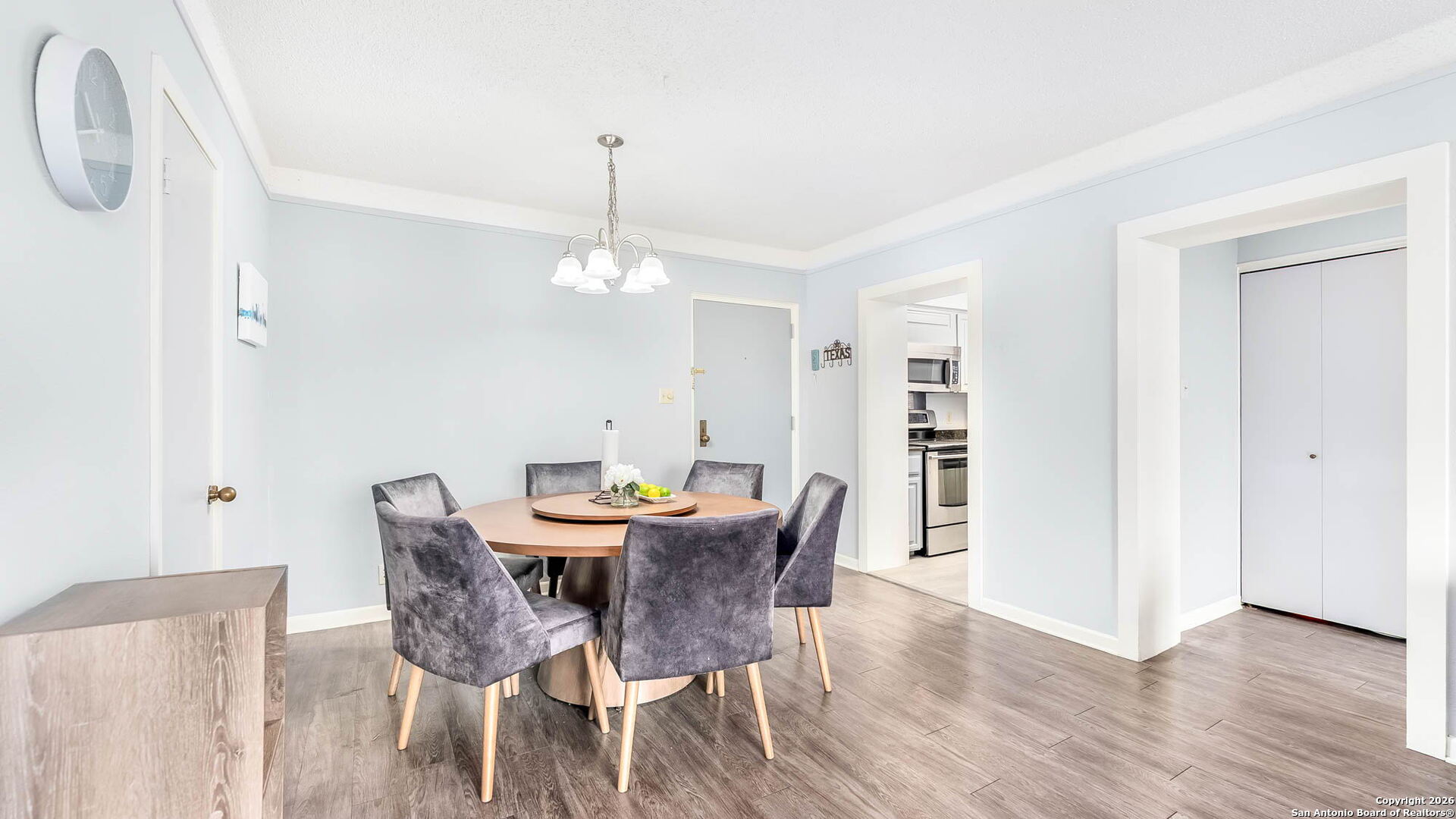 7701 Wurzbach Road, Unit 606 San Antonio, TX 78229 - Photo 3 of 10 a view of a dining room with furniture and wooden floor
