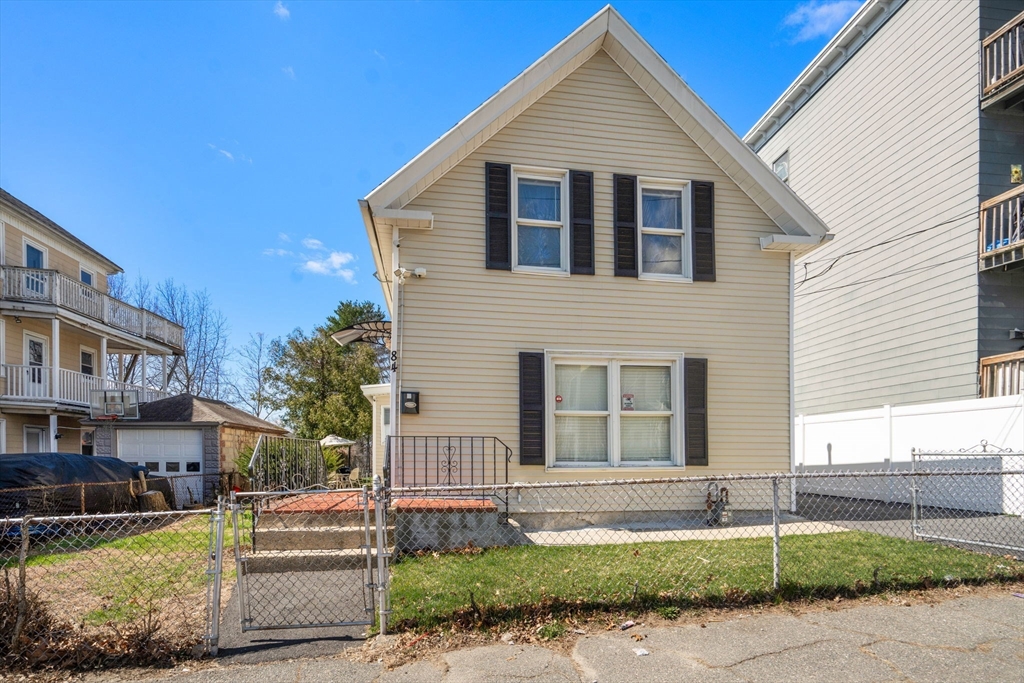 a view of a yard in front view of a house