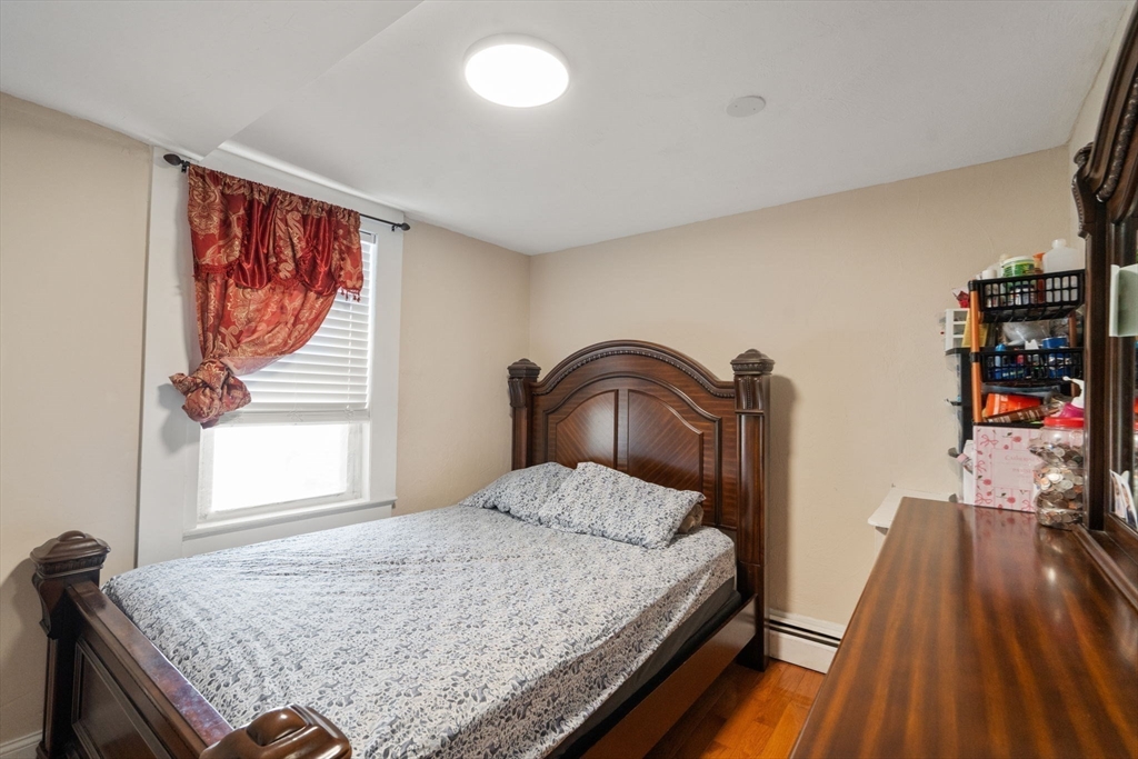 84 Howard Street Lawrence, MA 01841 - Photo 16 of 28 a bedroom with a bed and a dresser