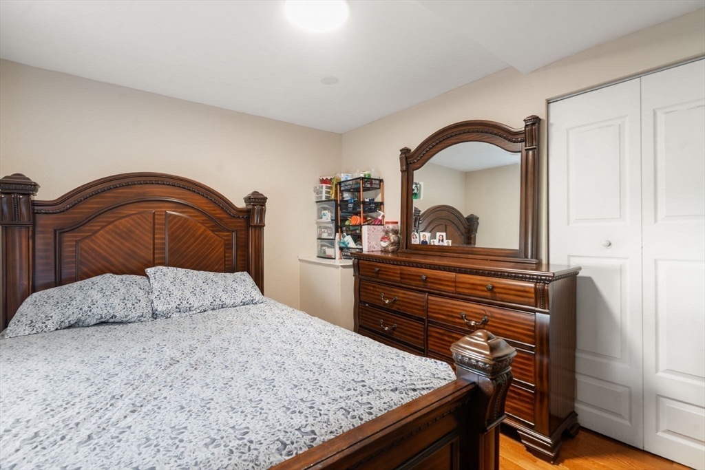 84 Howard Street Lawrence, MA 01841 - Photo 17 of 28 a bedroom with a bed and a dresser