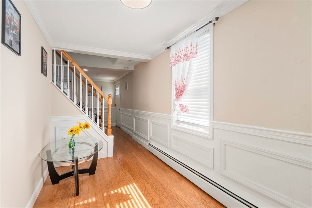 84 Howard Street Lawrence, MA 01841 - Photo 18 of 28 a hallway with wooden floor stairs and furniture