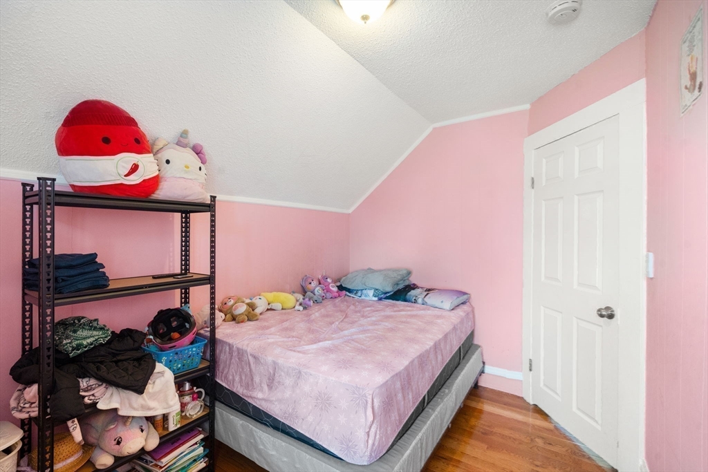 84 Howard Street Lawrence, MA 01841 - Photo 22 of 28 a bedroom with a bed and a window