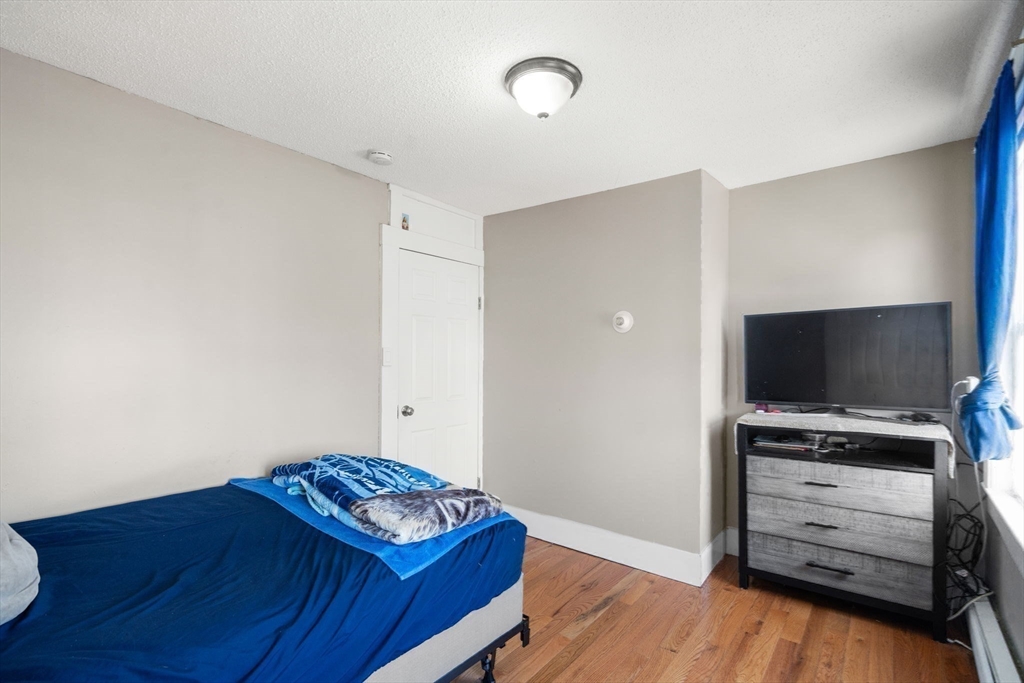 84 Howard Street Lawrence, MA 01841 - Photo 24 of 28 a living room with furniture and a flat screen tv