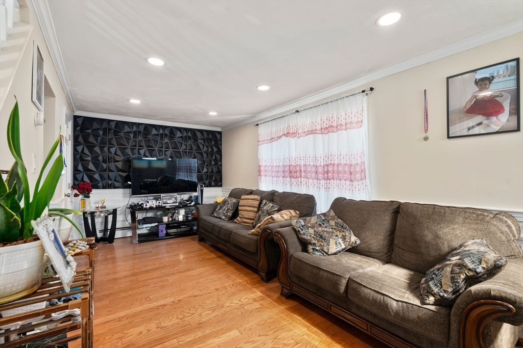 84 Howard Street Lawrence, MA 01841 - Photo 3 of 28 a living room with furniture and a flat screen tv