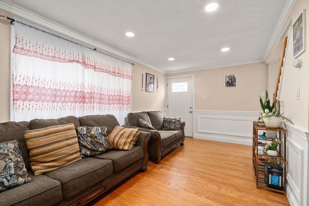 84 Howard Street Lawrence, MA 01841 - Photo 4 of 28 a living room with furniture and a flat screen tv