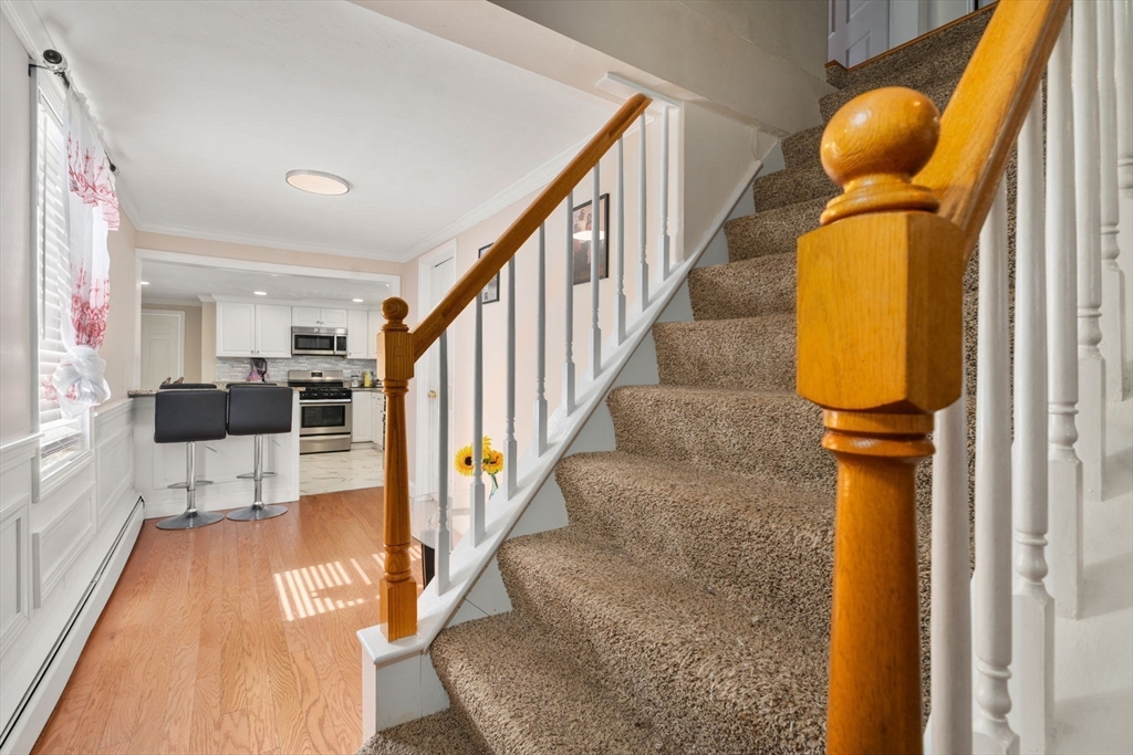 84 Howard Street Lawrence, MA 01841 - Photo 8 of 28 a view of entryway and hall with wooden floor
