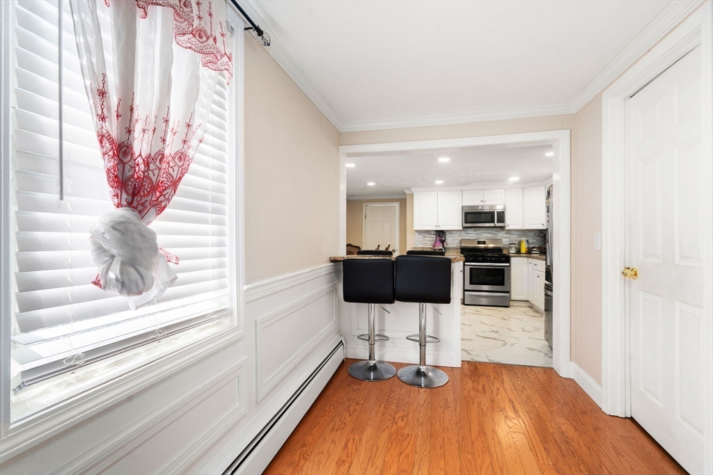84 Howard Street Lawrence, MA 01841 - Photo 9 of 28 a view of a living room with a stove top oven and kitchen island