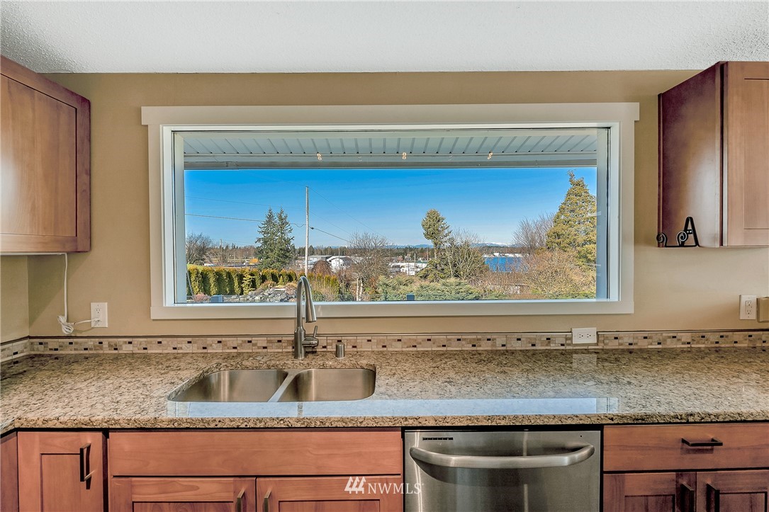 5874 Laurel Ridge Way Bellingham, WA 98226 - Photo 16 of 40 a kitchen with granite countertop a sink and a stove