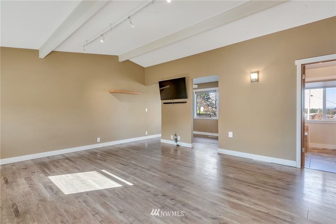 5874 Laurel Ridge Way Bellingham, WA 98226 - Photo 21 of 40 a view of an empty room with wooden floor and a window