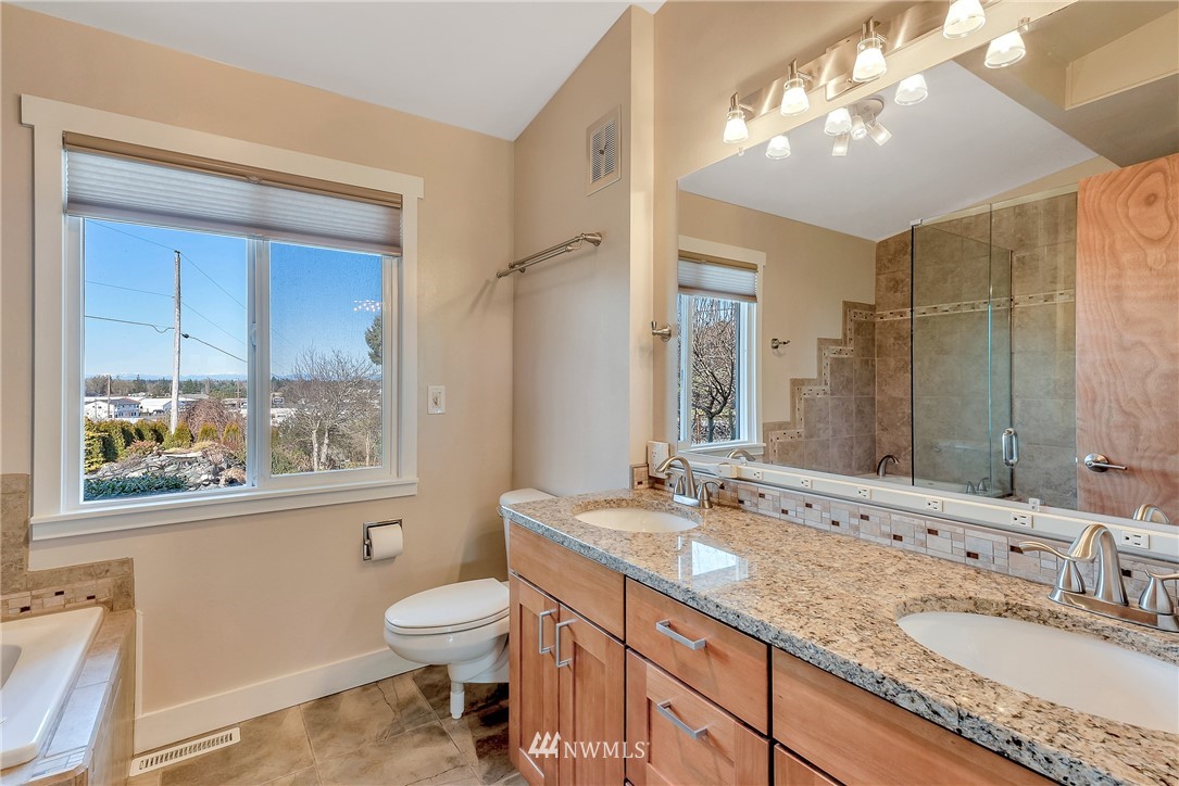 5874 Laurel Ridge Way Bellingham, WA 98226 - Photo 22 of 40 a bathroom with a granite countertop double vanity sink a mirror and a toilet
