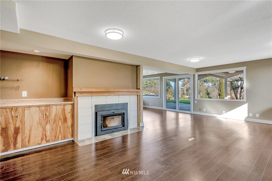 5874 Laurel Ridge Way Bellingham, WA 98226 - Photo 27 of 40 a view of an empty room with wooden floor and a fireplace