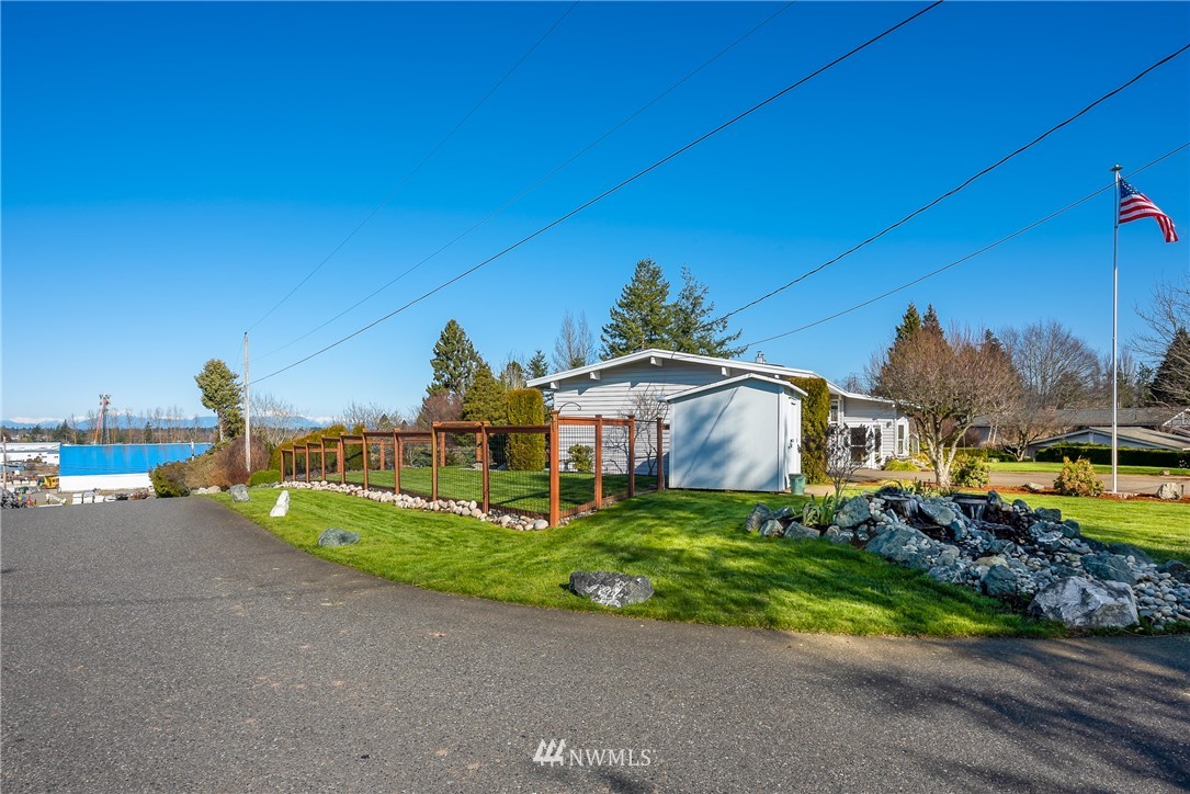 5874 Laurel Ridge Way Bellingham, WA 98226 - Photo 38 of 40 a front view of a house with a yard and potted plants