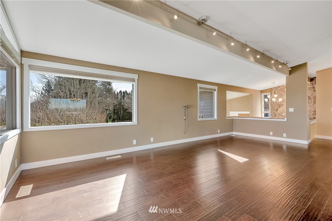 5874 Laurel Ridge Way Bellingham, WA 98226 - Photo 9 of 40 a view of an empty room with wooden floor and a window