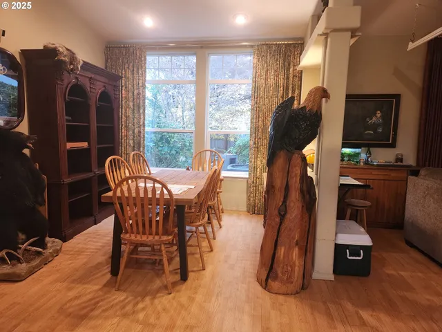 a dining room with furniture window and wooden floor