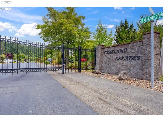 a view of a backyard with iron fence