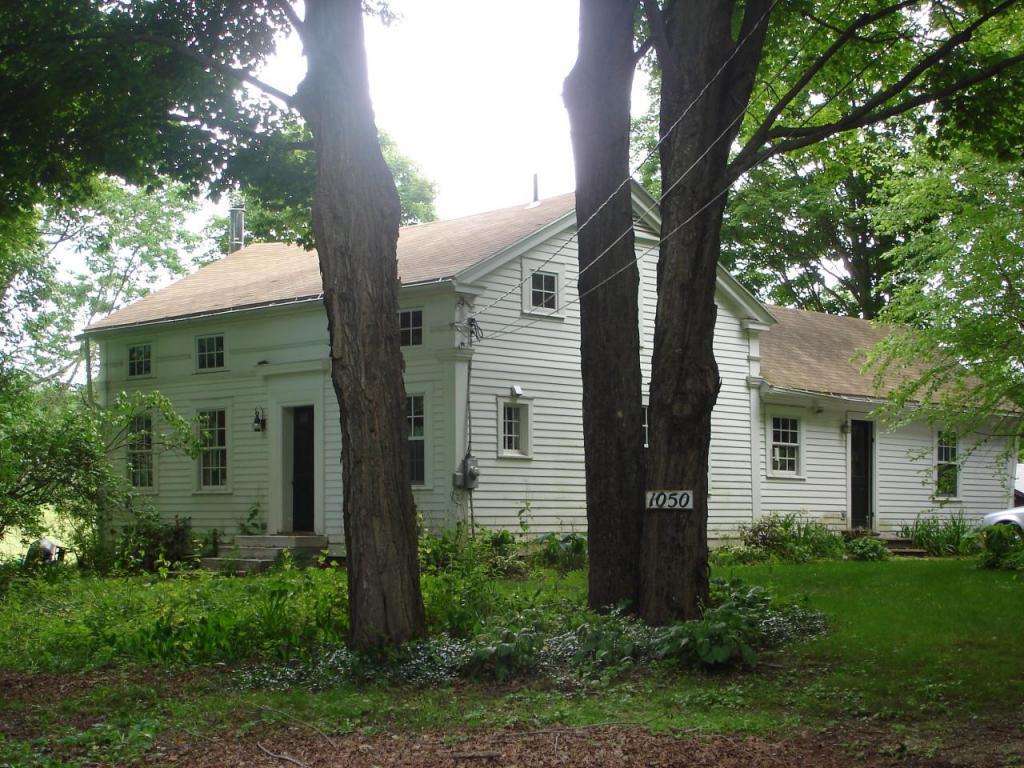 a front view of house with a garden