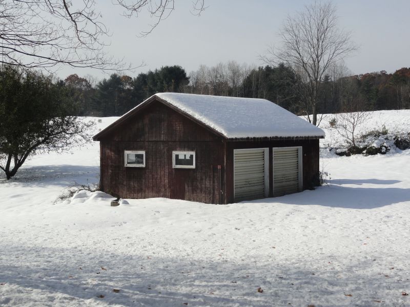 1050 W Road Richmond, MA 01254 - Photo 11 of 11 a front view of a house with a yard covered in snow