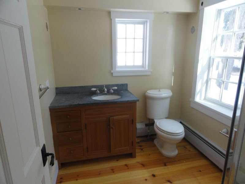 1050 W Road Richmond, MA 01254 - Photo 3 of 11 a bathroom with a toilet a sink a window and mirror